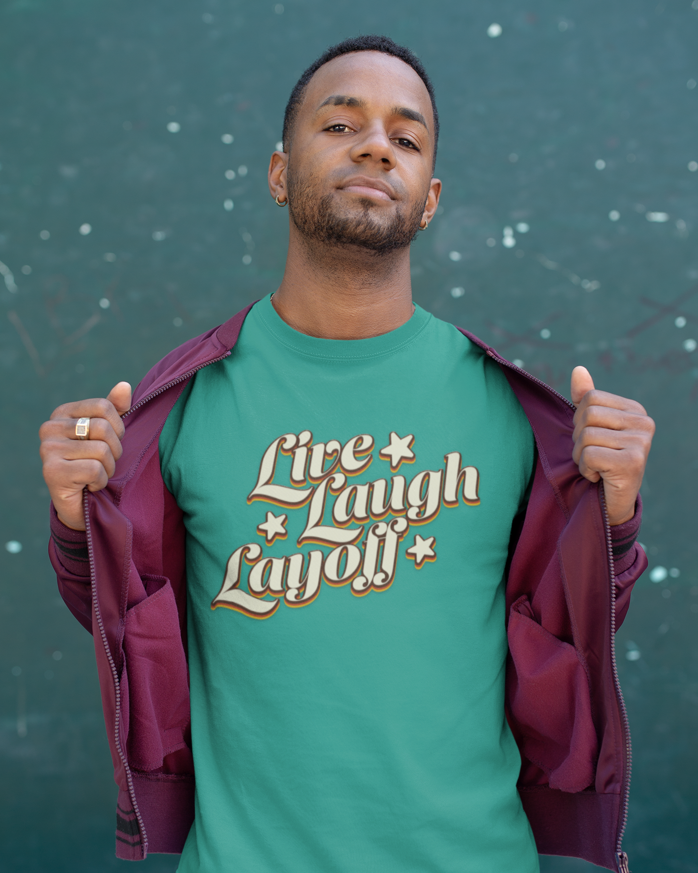 Live Love Layoff Humorous TShirt Man wearing a green t-shirt with 'Live Laugh Layoff' text against a dark background