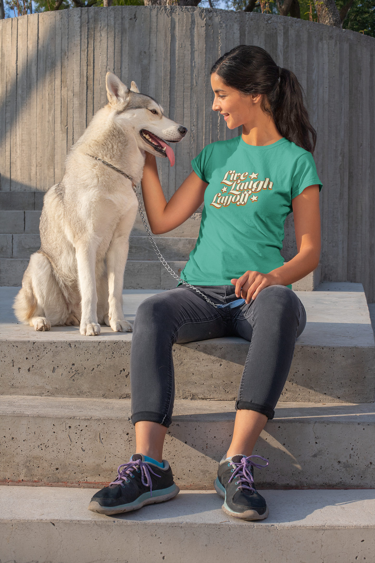 Live Love Layoff Humorous TShirt Woman  Woman sitting on steps with a dog, wearing a green t-shirt with text