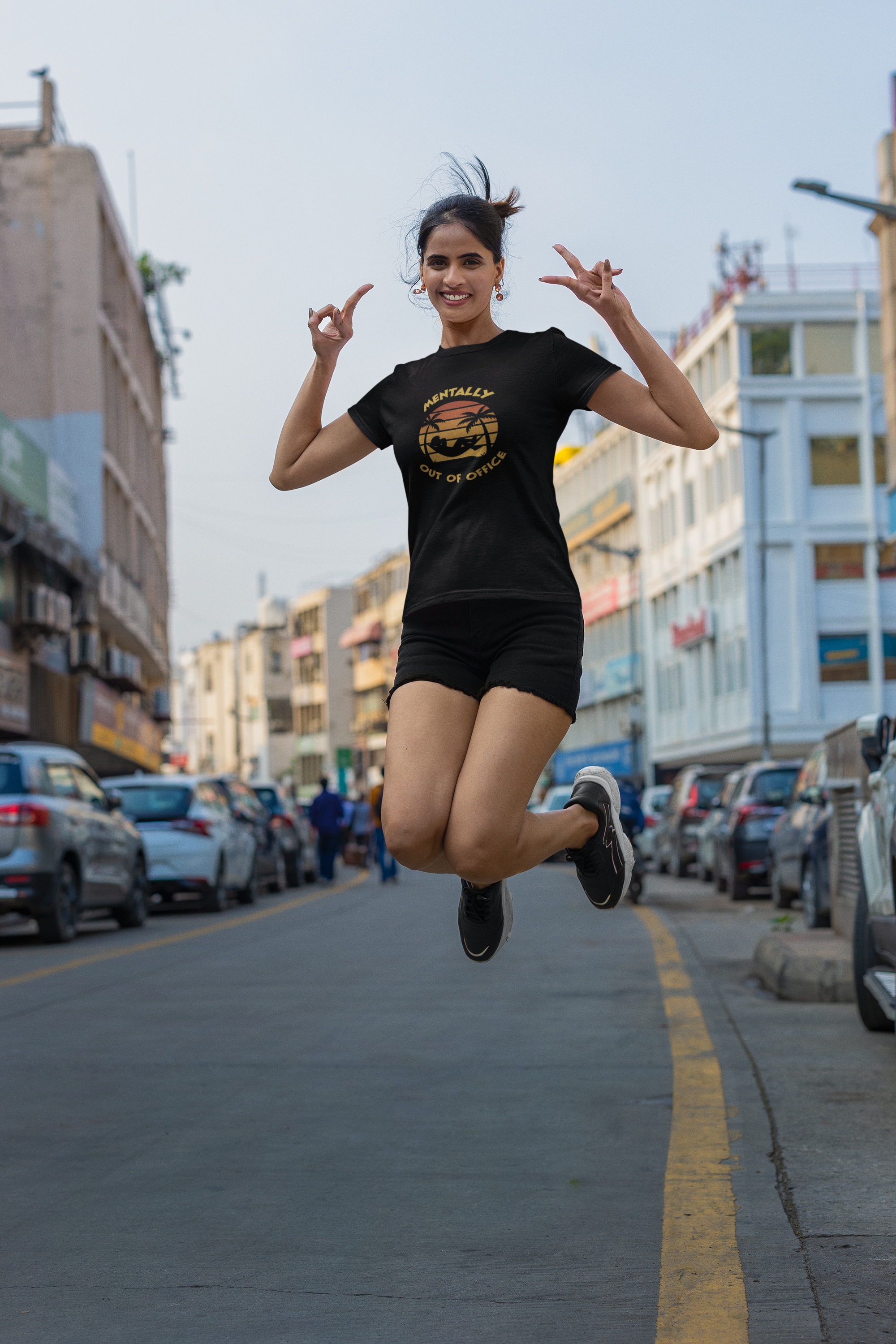Mentally Out Of Office Tee Woman jumping in the middle of a street with buildings and cars in the background