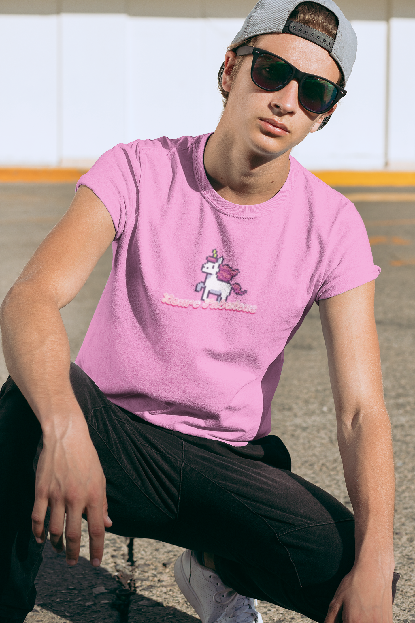 Neurofabulous T-Shirt Person wearing a pink t-shirt with a unicorn graphic and sunglasses, sitting outdoors.