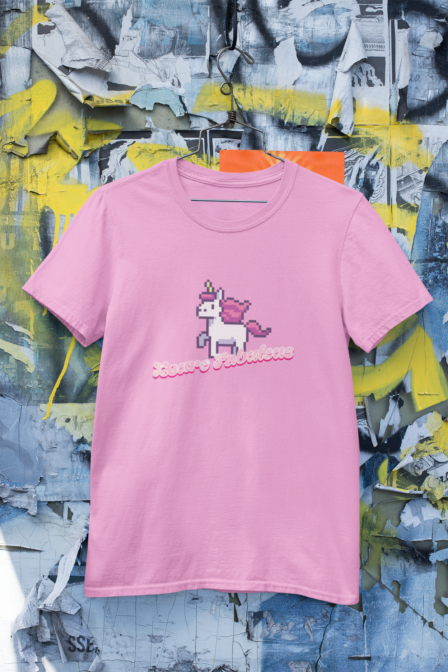 Neurofabulous T-Shirt Pink t-shirt with a unicorn graphic and text on a colorful, abstract background