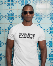 Organic Tee I'm In This Zoom Don't Know Why Man wearing a white t-shirt with text in front of a blue tiled wall.
