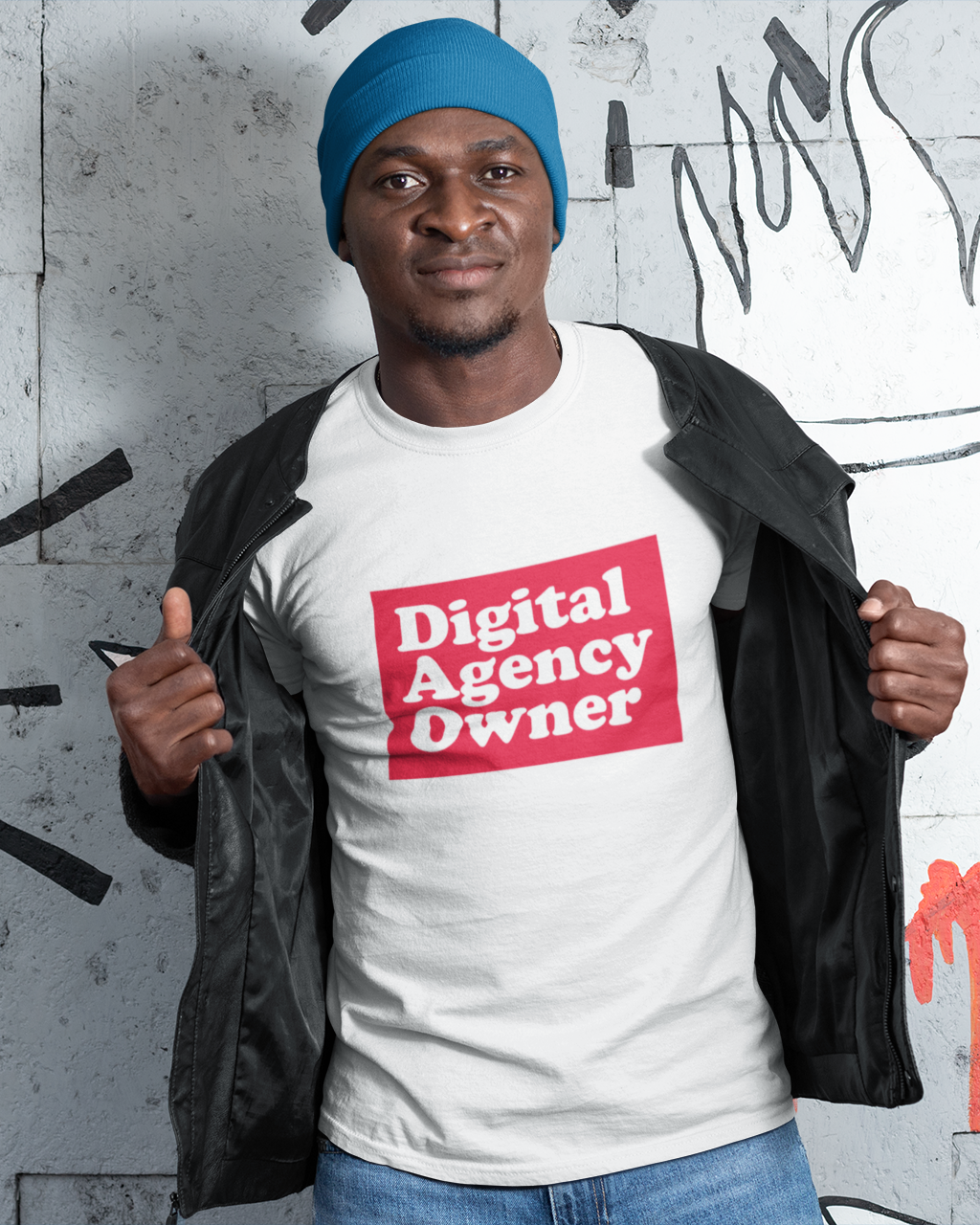 Person wearing a 'Digital Agency Owner' t-shirt in front of a graffiti wall.