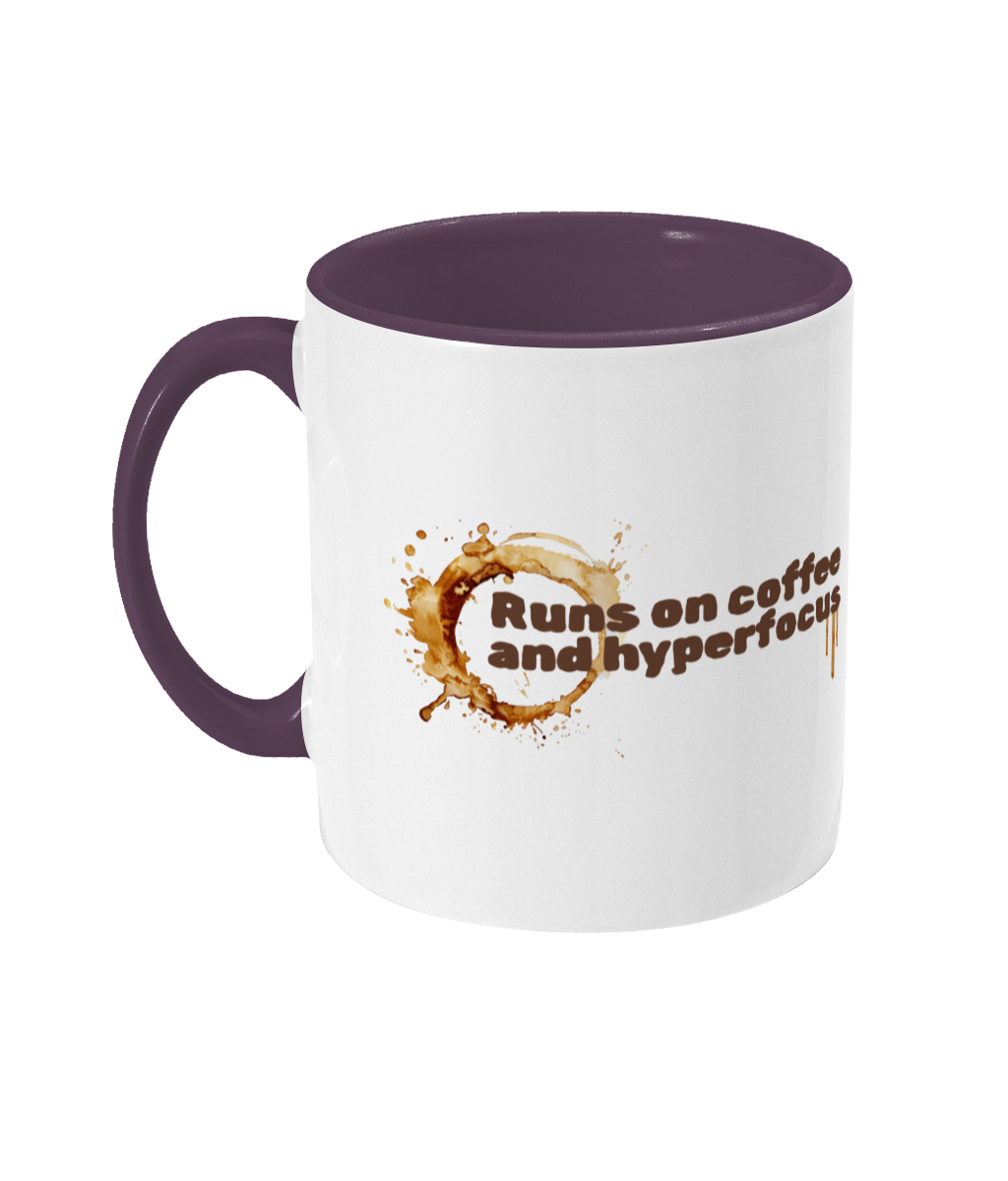 White mug with purple handle and interior, featuring a coffee-themed design and text.