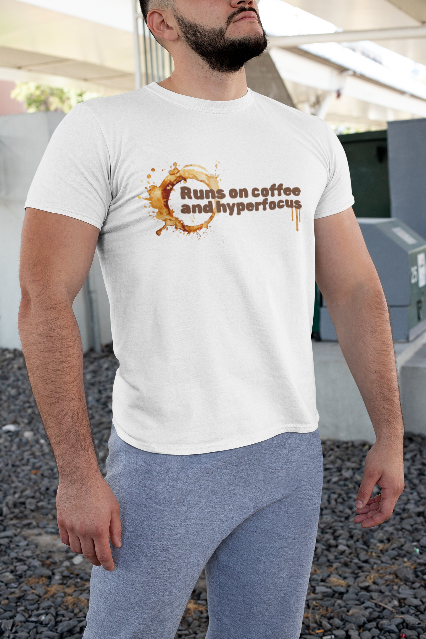 Buff Man Woman in Man in White t-shirt with text 'Runs on coffee and hyperfocus' and coffee design on a white background