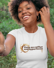Woman in Man in White t-shirt with text 'Runs on coffee and hyperfocus' and coffee design on a white background