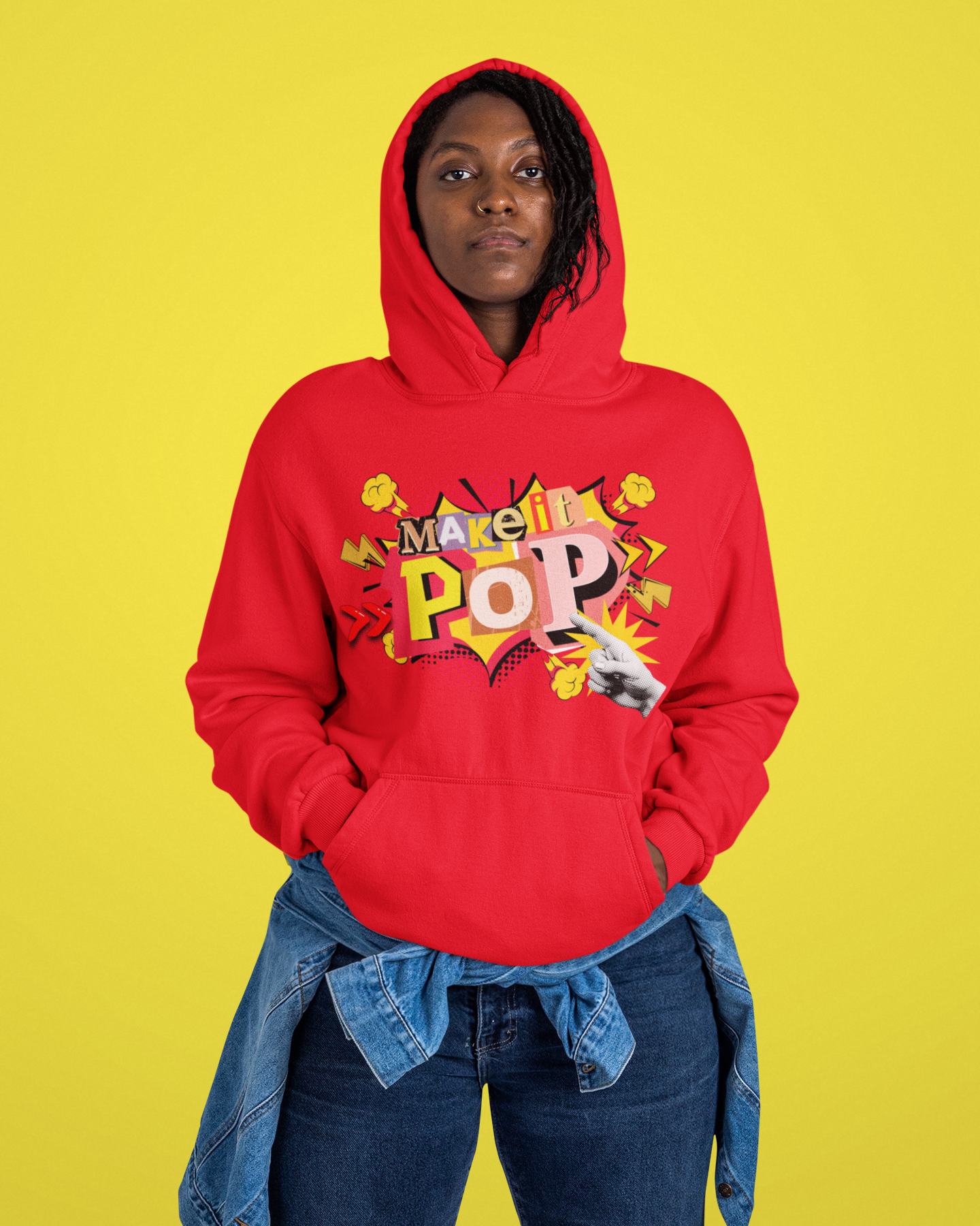Person wearing a red hoodie with colorful text and graphics on a yellow background