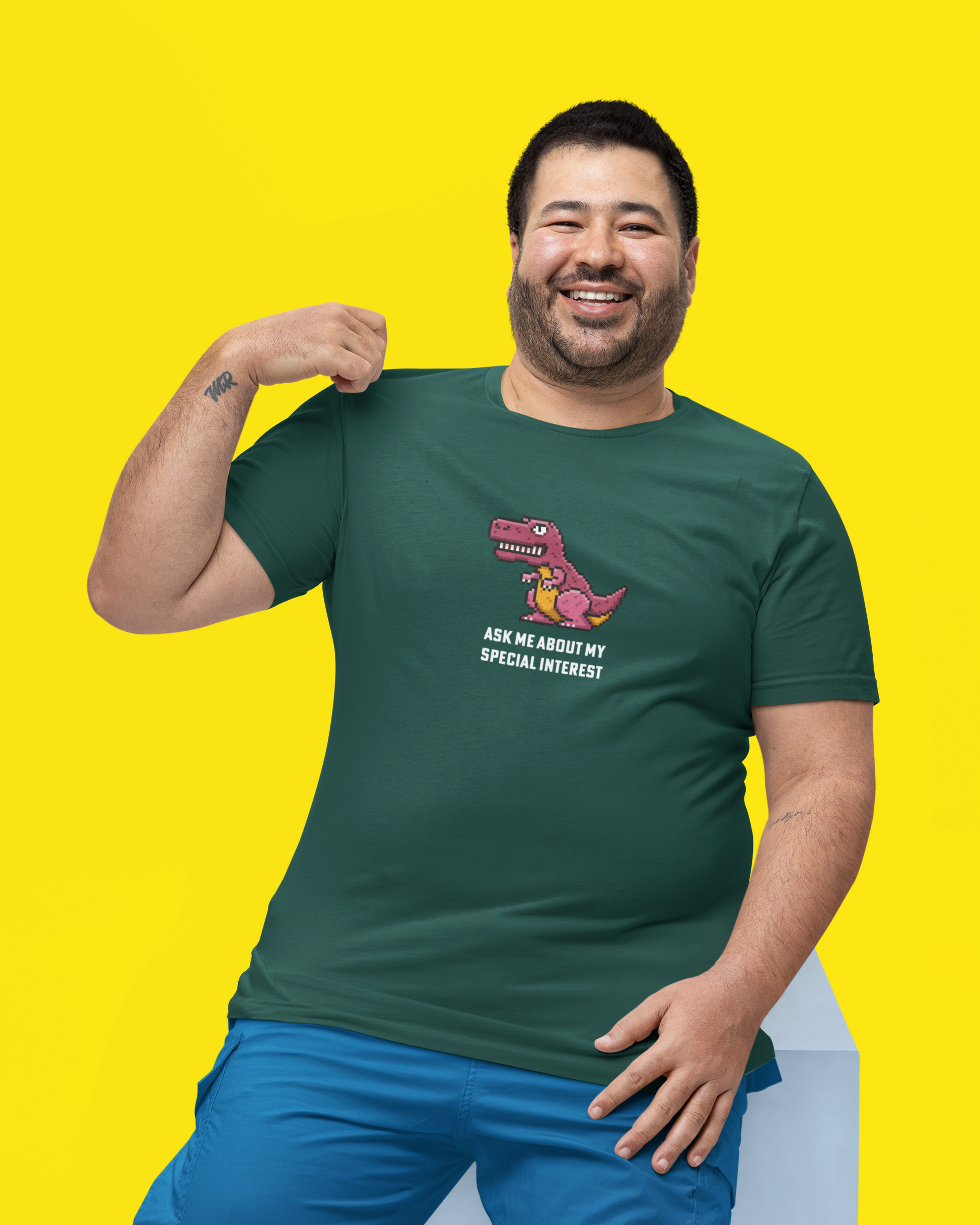Man wearing a green t-shirt with a graphic design on a yellow background