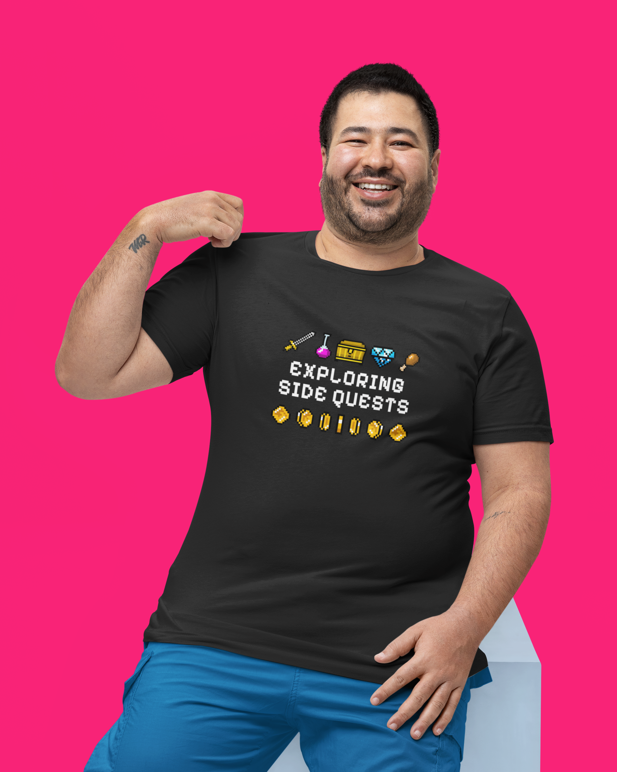 Man wearing a black t-shirt with text and graphics on a pink background