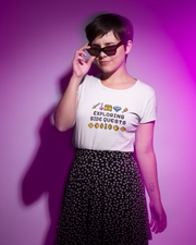 Person wearing a white t-shirt with text and graphics against a purple background