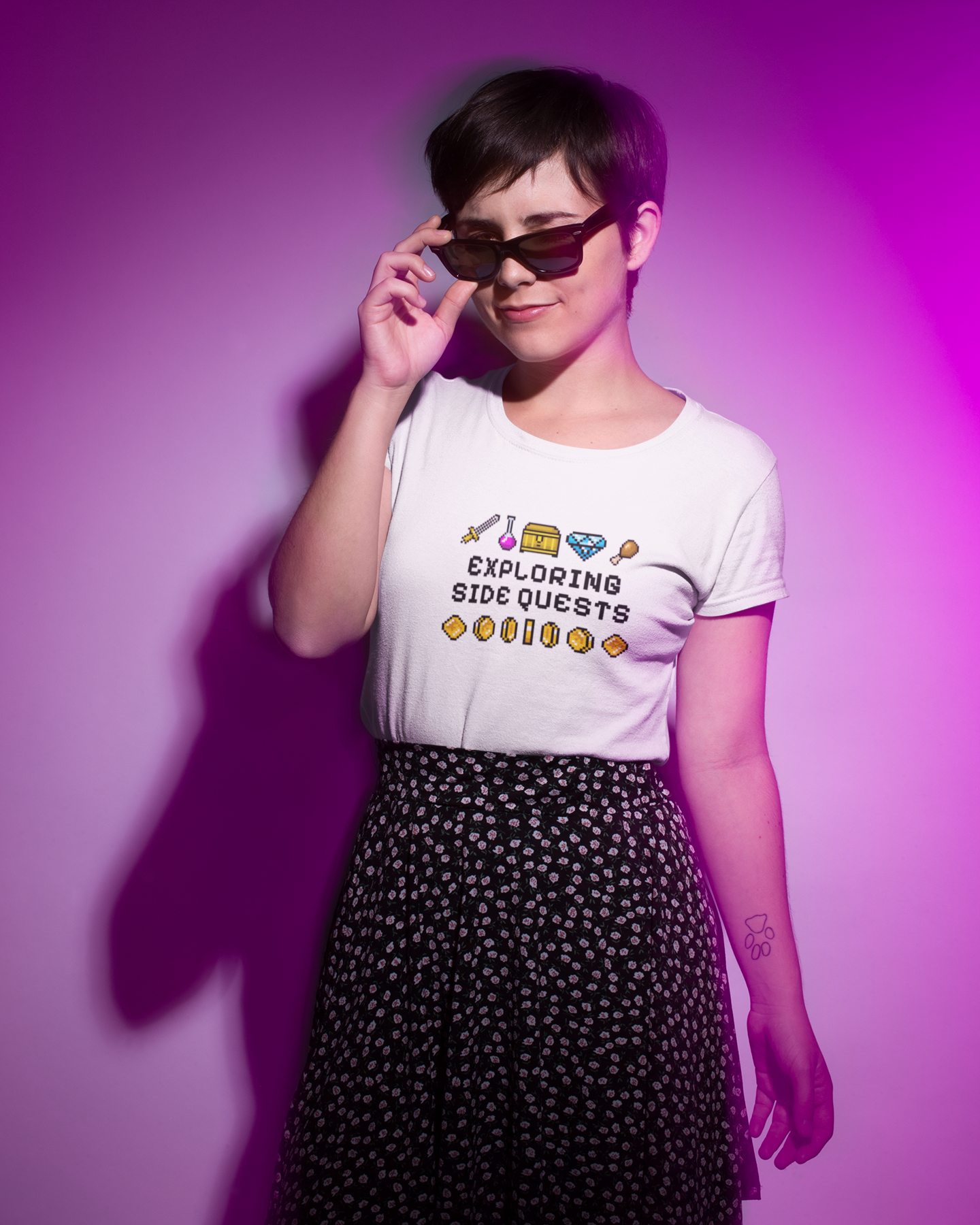 Person wearing a white t-shirt with text and graphics against a purple background