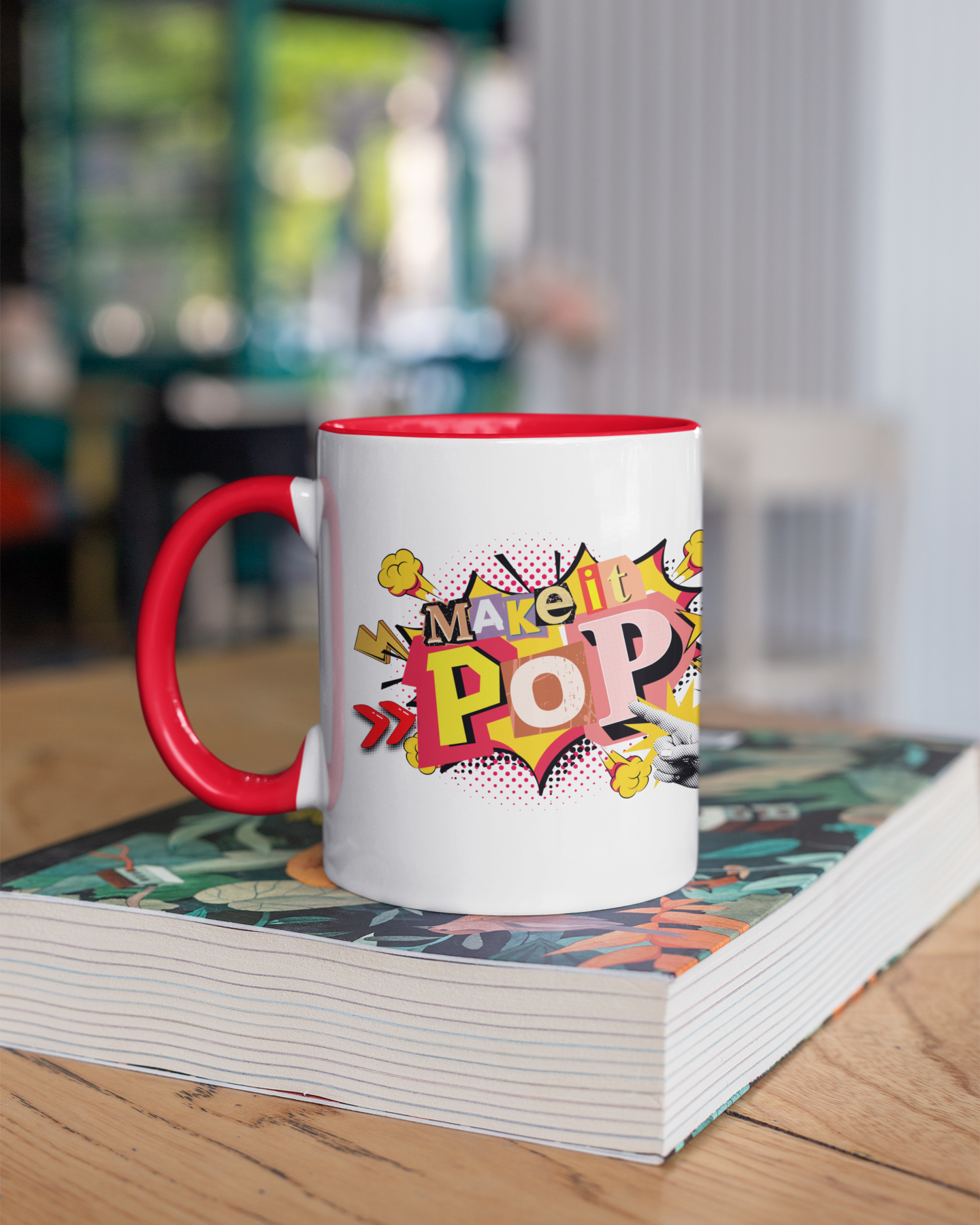 Mug with 'Make it Pop' design on a stack of books