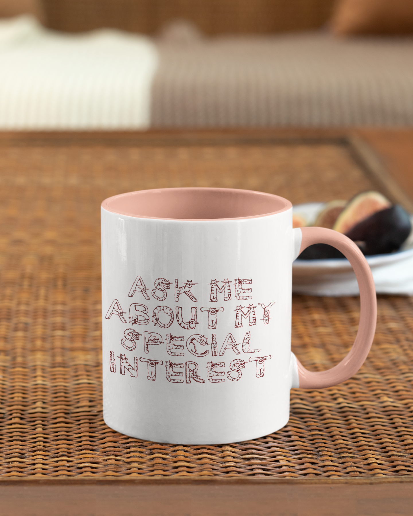 Mug with 'Ask me about my special interest' text on a woven mat