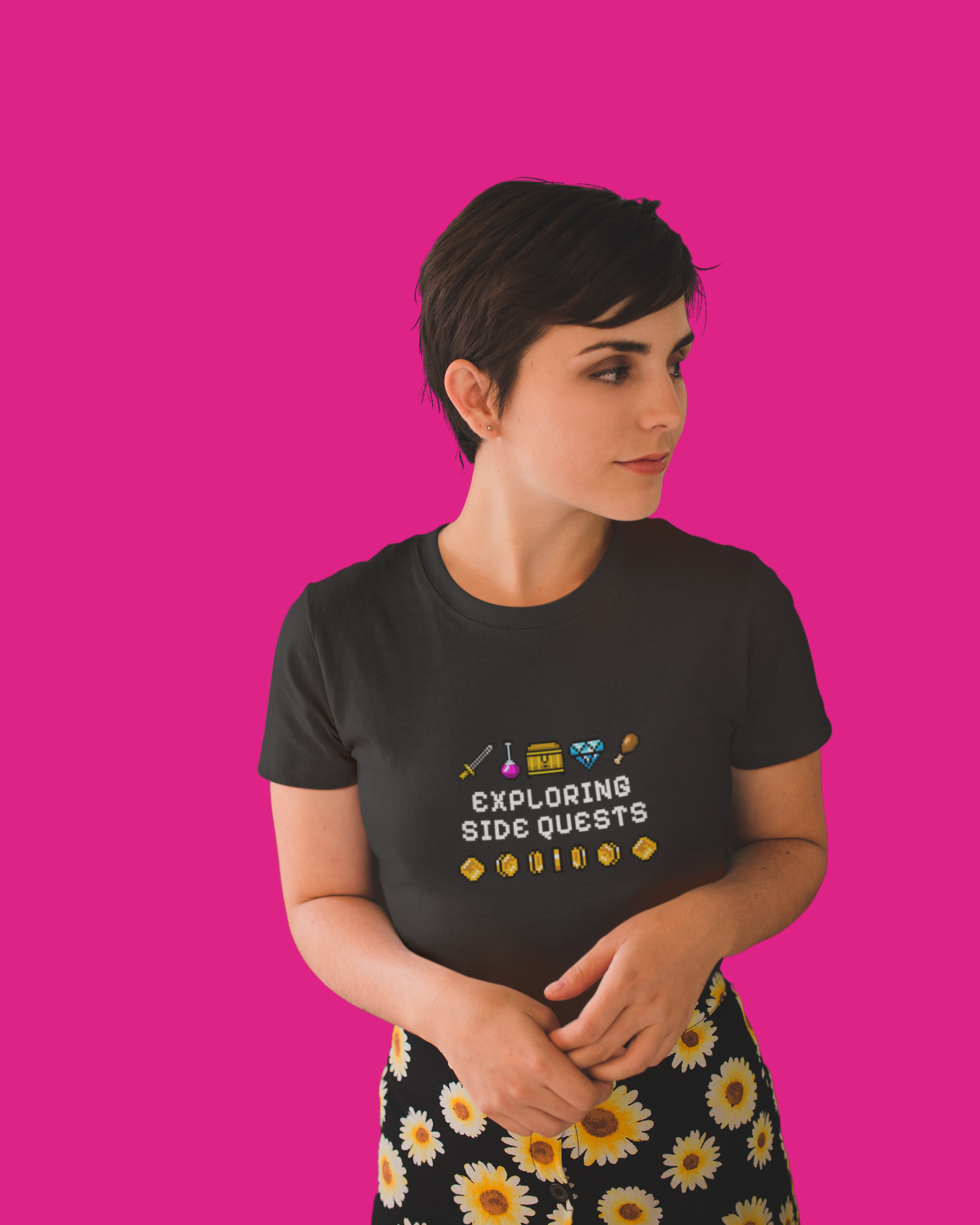 Person wearing a black t-shirt with text and graphics on a pink background