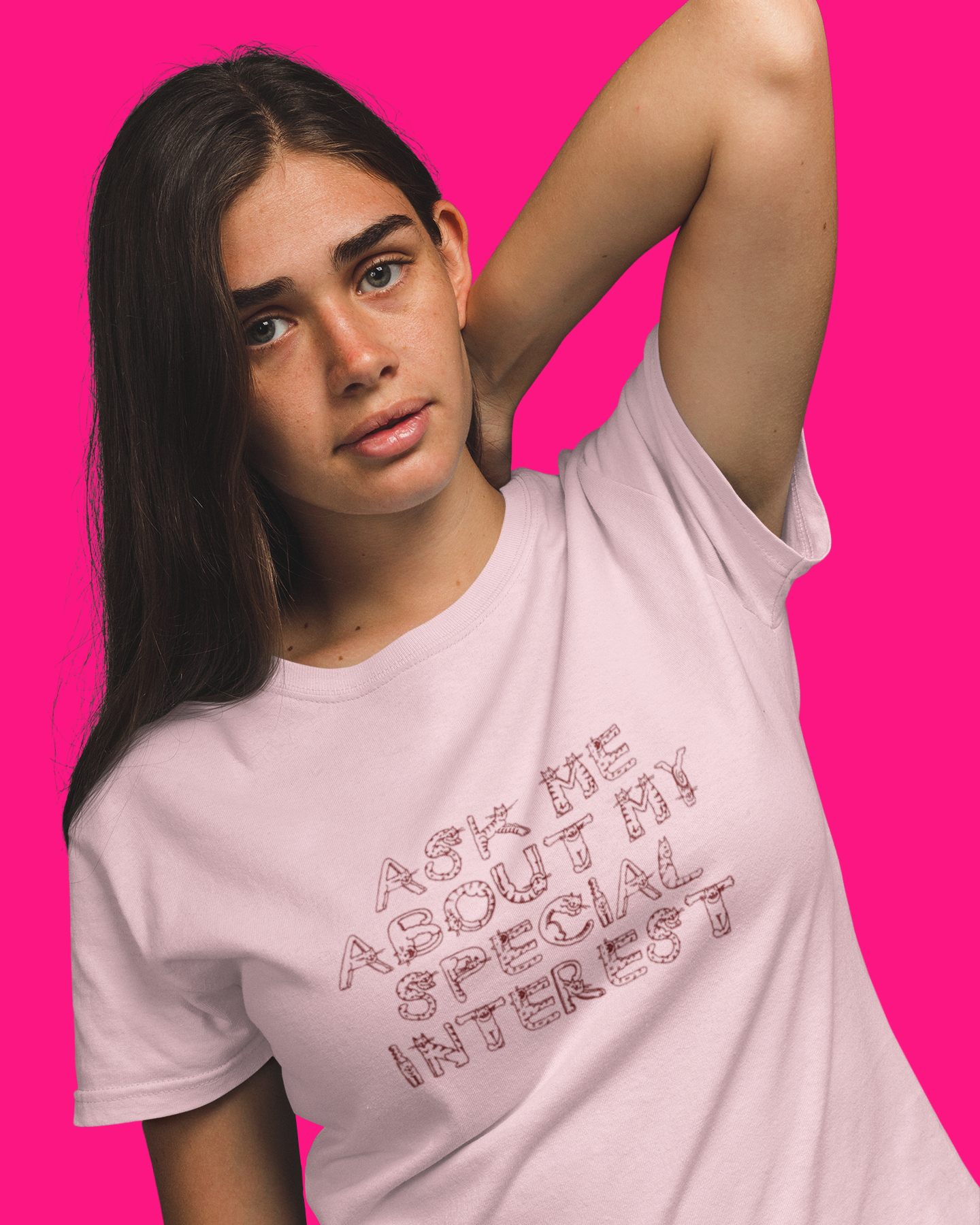 Person wearing a pink t-shirt with text on a bright pink background